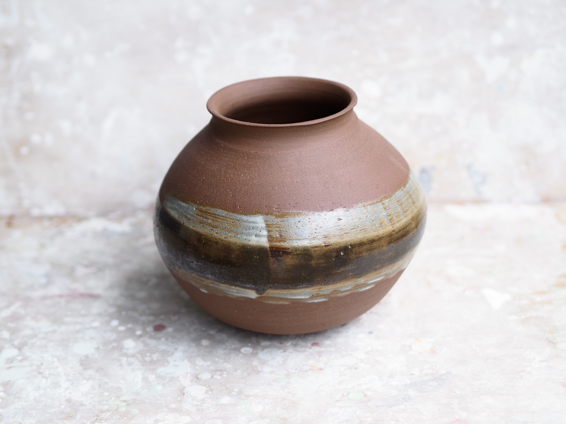 Round red earth vase