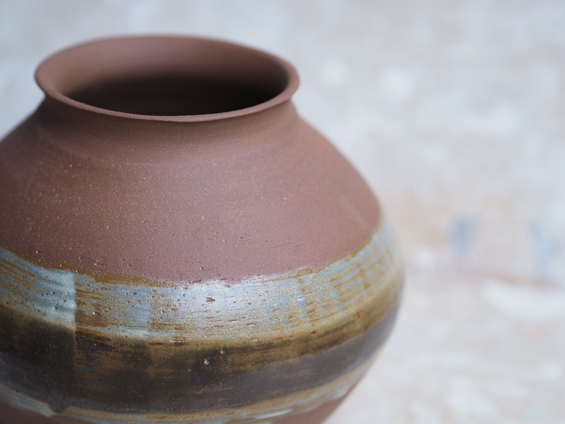 Round red earth vase