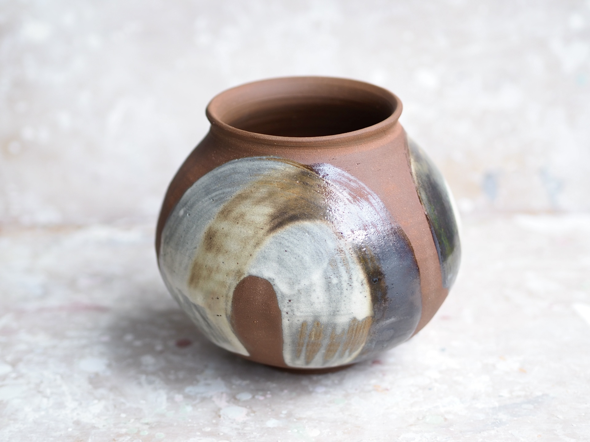 Round red earth vase